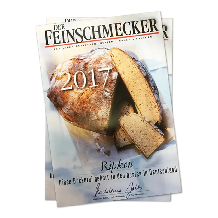 Das Titelbild der Zeitschrift Der Feinschmecker zeigt einen runden Brotlaib mit ein paar angeschnittenen Scheiben und der Jahreszahl 2017 in großer Schrift. In der Überschrift wird die Bäckerei Ripken als eine der besten in Deutschland erwähnt.